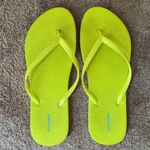 Neon yellow flip flops